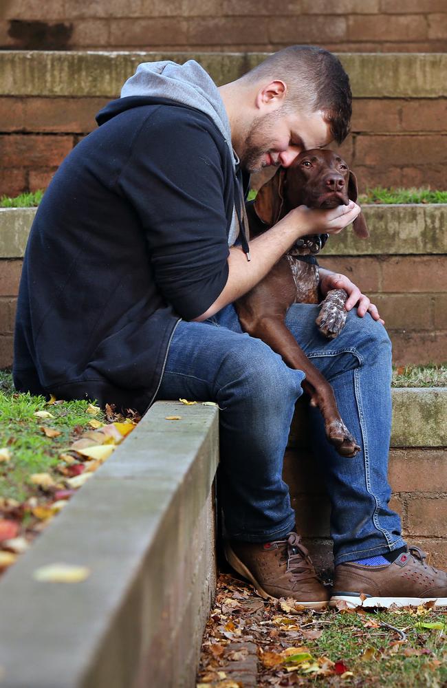 Man’s best friend: Frankie gets a cuddle from Jeremy Medlock. Picture: Richard Dobson