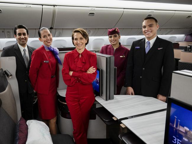 BRISBANE, AUSTRALIA - DECEMBER 04: In this image released on December 12, Jayne Hrdlicka, CEO of Virgin Australia, joins crew from both Virgin Australia and Qatar Airways onboard a Qatar Airways Boeing 777 at Brisbane Airport on December 04, 2024 in Brisbane, Australia. A new partnership between the two airlines has been launched which will deliver more value and choice to Australians, providing opportunities to travel to over 100 destinations across Europe, the Middle East and Africa. From December 12, Aussies can book Virgin Australia's new direct services from Sydney, Brisbane and Perth to Doha for travel from June 2025, with Melbourne set to launch later in 2025. These flights will be operated by Virgin Australia using Qatar Airways' spacious Boeing 777s, renowned for their Qsuite Business Class. (Photo by James D. Morgan/Getty Images for Virgin Australia)