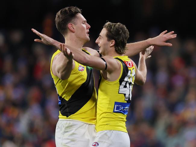 Jacob Koschitzke and Tyler Sonsie celebrate a Richmond goal on Thursday night. Picture: James Elsby/AFL Photos via Getty Images