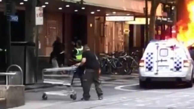 Michael Rogers trying to ram the offender during the Bourke St attack. Source: Twitter