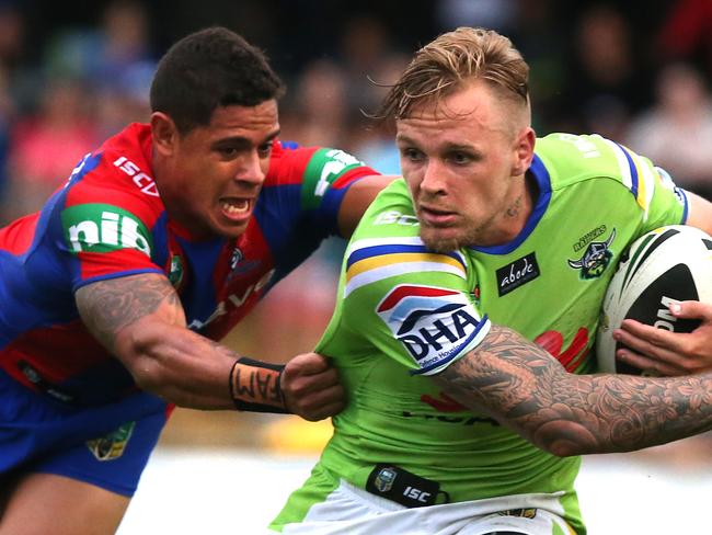 Raiders vs Newcastle Knights trial match at Seiffert Oval in Queanbeyan, NSW. Knights Dane Gagai dives to tackle Raiders Blake Austin.