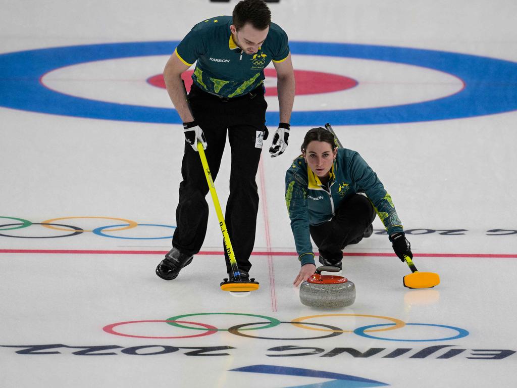 Australia's Tahli Gill (R) and Dean Hewitt compete during the mixed doubles round robin session 1 game of the Beijing 2022 Winter Olympic Games curling competitio.