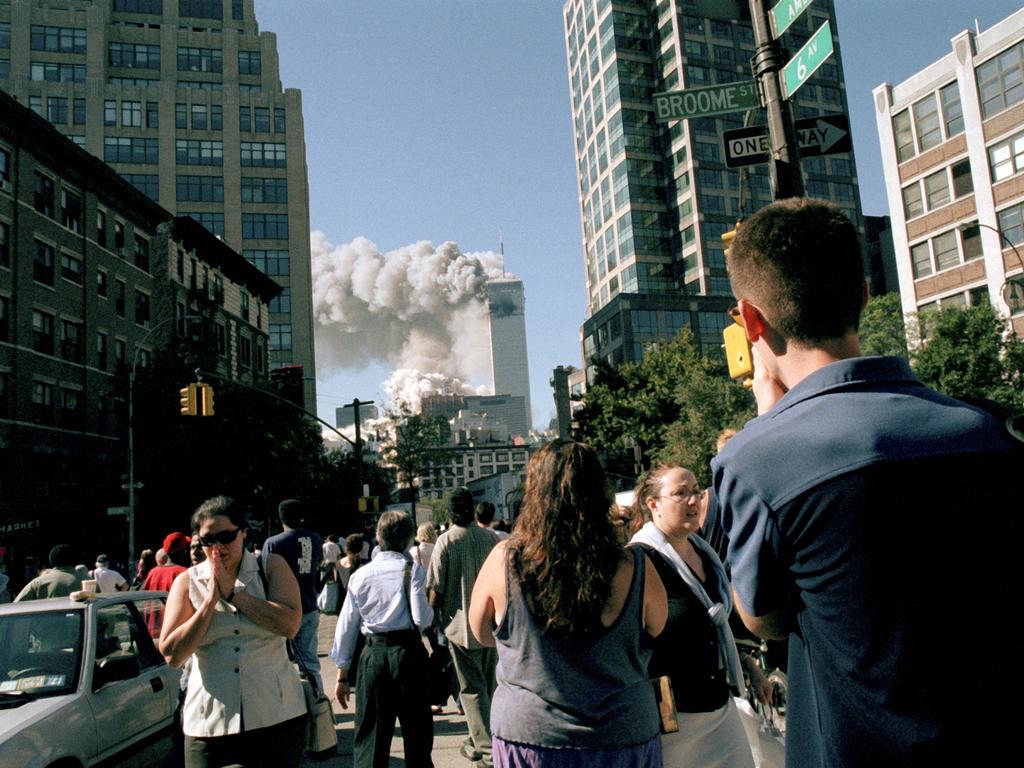 People watch from Sixth Ave in Soho as the towers collapse. Picture: Alamy