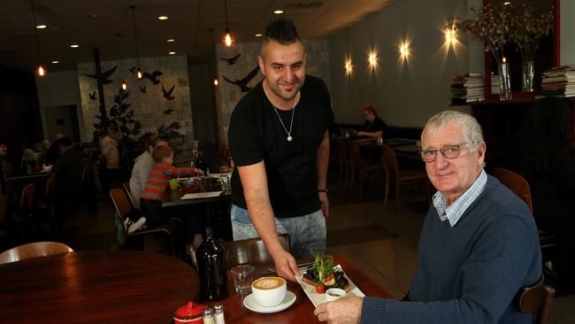 Chapter Too’s Ramee Agha serves food to Allan Payne after the Heathmont cafe was allowed to welcome back dine-in customers. Picture: Hamish Blair