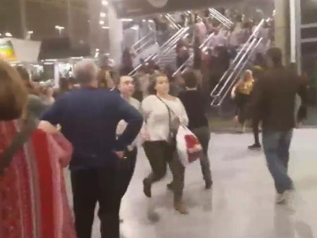 Concert goers are seen escaping the main arena after an explosion at an Ariana Grande concert in Manchester.  Picture:  Supplied
