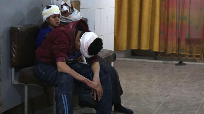 Wounded Syrians wait to receive treatment at a makeshift hospital in Kafr Batna. Picture: Ammar Suleiman/AFP