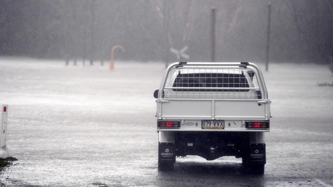 Flood waters block the road between Airlie Beach and Proserpine. Picture: AAP