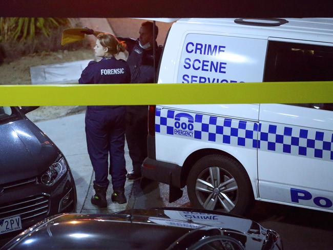 Forensic officers talk at the Waverley Gardens shopping centre crime scene. Picture: Patrick Herve