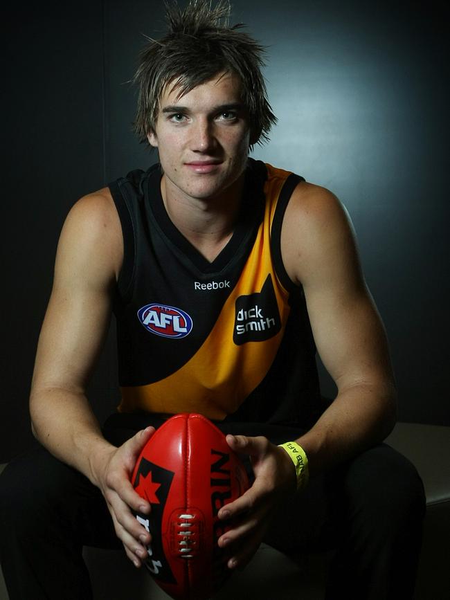 Dustin Martin tries on the yellow and black jumper for the first time.