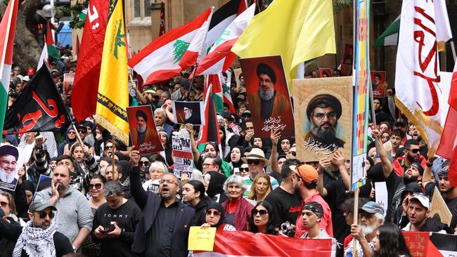 A Hezbollah flag is seen at a pro-palestine rally in Sydney, along with pictures of slain Hezbollah leader Hassan Nasrallah. Picture: NewsWire / Damian Shaw