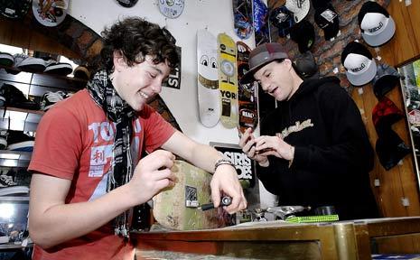 Travis Watson (right), the owner of 36 Chambers in Molesworth Street, Lismore, helps Jasper Hancock, 13, of Nimbin, replace broken trucks on his skateboard. Picture: David Nielsen