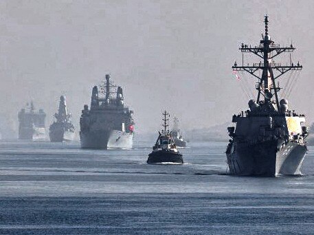 This handout image provided by the official Twitter account of Commodore Steve Moorhouse, Royal Navy, Commander of the UK Carrier Strike Group on July 6, 2021 shows a view of the vessels of the strike group sailing behind the Royal Navy's HMS Queen Elizabeth aircraft carrier through Egypt's Suez Canal. (Photo by - / Royal Navy / AFP) / XGTY / XGTY / RESTRICTED TO EDITORIAL USE - MANDATORY CREDIT  " AFP PHOTO / ROYAL NAVY / CROWN COPYRIGHT" -  NO MARKETING NO ADVERTISING CAMPAIGNS - DISTRIBUTED AS A SERVICE TO CLIENTS  -  NO ARCHIVE