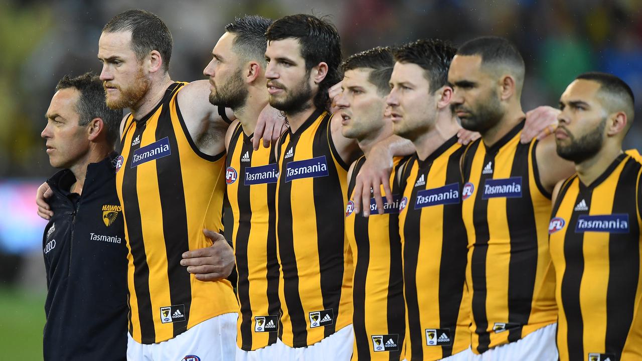 (L-R) Hawks coach Alastair Clarkson, Jarryd Roughhead, Jack Gunston, Ben Stratton, Luke Breust, Liam Shiels, Shaun Burgoyne and Jarman Impey are seen during the national anthem is seen during the First Qualifying Final between the Richmond Tigers and the Hawthorn Hawks in Week 1 of the AFL Finals Series at the MCG in Melbourne, Thursday, September 6, 2018. (AAP Image/Julian Smith) NO ARCHIVING, EDITORIAL USE ONLY