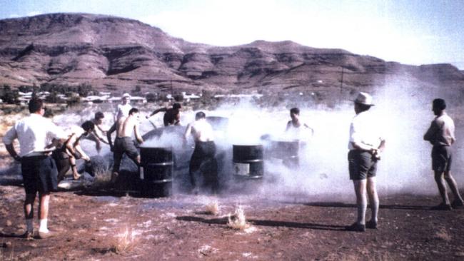 Workers shovel raw blue asbestos tailings into drums at an asbestos shovelling competition at Wittenoom, in the Pilbara, WA, in 1962.