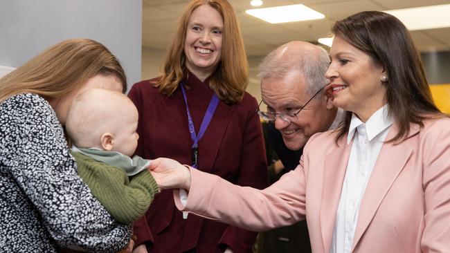 Prime Minister Scott Morrison and his wife Jenny meet a young guest at Melbourne IVF on Sunday. Picture: Jason Edwards