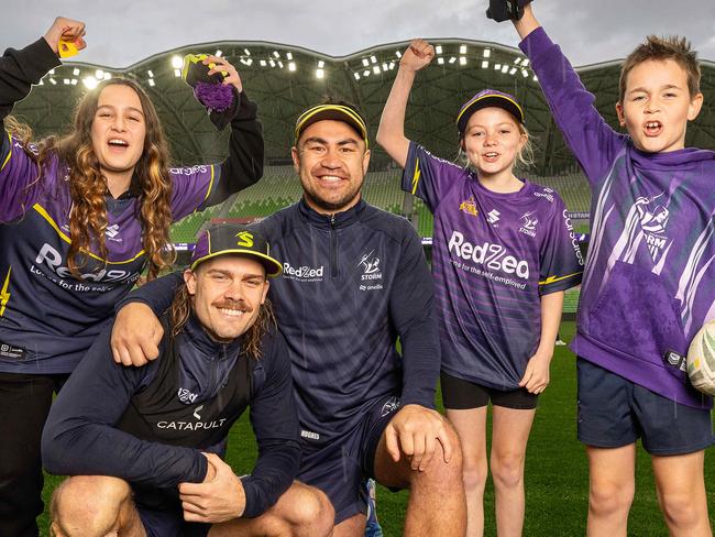 MELBOURNE, SEPTEMBER 11, 2024: Melbourne Storm training ahead their hosting an NRL qualifying final at AAMI Park on September 14, against the Cronulla Sharks. Ryan Papenhuyzen and Jahrome Hughes with fanes L to R Olivia, 12, Isabella, 11, and Aidan, 9. Picture: Mark Stewart