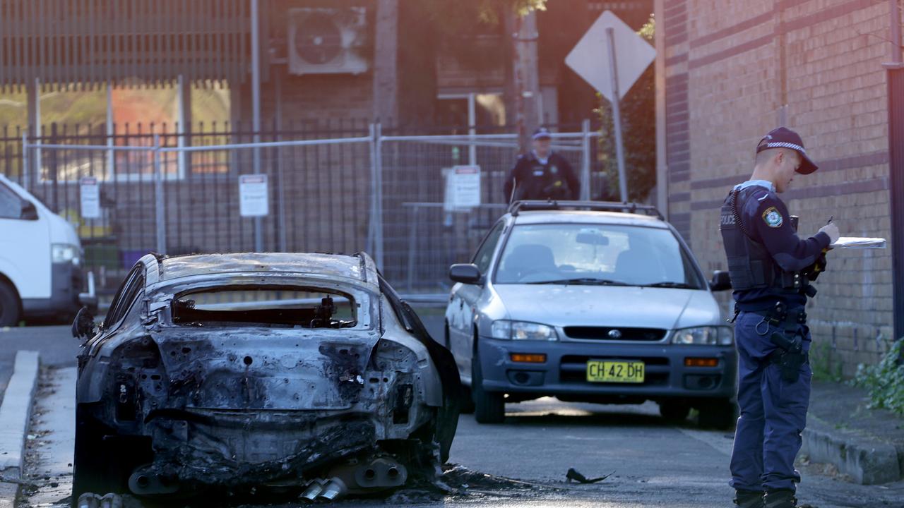 A burnt-out Kia Stinger in Norwood Lane, Marrickville, after the shooting. Picture: NCA NewsWire / Damian Shaw