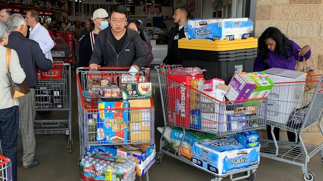 People buy water, food and toilet paper at a store in Los Angeles, as they begin to stockpile essentials from fear that supplies will be affected by the spread of coronavirus. Picture: AFP