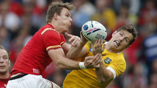 Wallaby fly-half Bernard Foley, contesting the ball with Liam Williams, was thrown in the deep end against Wales. Picture: AP