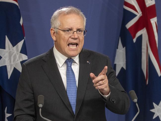 SYDNEY, AUSTRALIA - APRIL 19: Australian Prime Minister Scott Morrison points during a press conference on April 19, 2021 in Sydney, Australia. Prime Minister Scott Morrison has announced a Royal Commission into veteran suicides after months of increasing pressure from former soldiers and politicians. The inquiry will examine all aspects of service in the Australian Defence Force and the experience of those transitioning from active service with Minister for veterans' affairs Darren Chester to lead the consultations. (Photo by Jenny Evans/Getty Images)