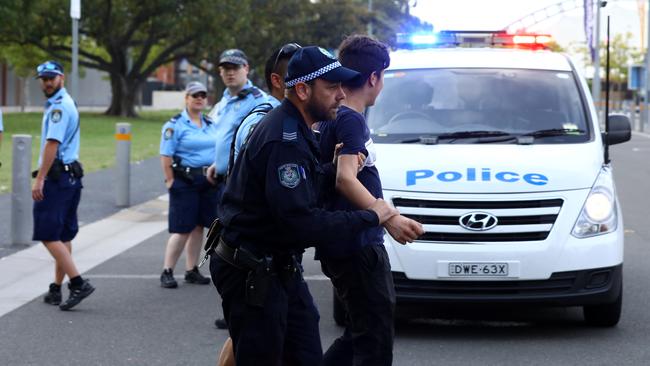 Police escort a young reveller away from Hardcore Till I Die. Picture: Matrix