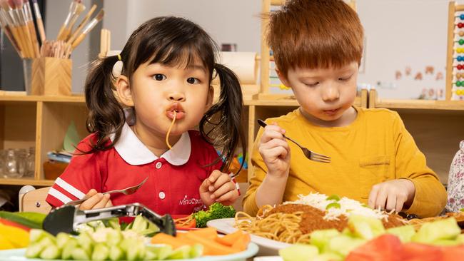 MindChamps students Nicole and Archer tuck in. Picture: Chris Pavlich