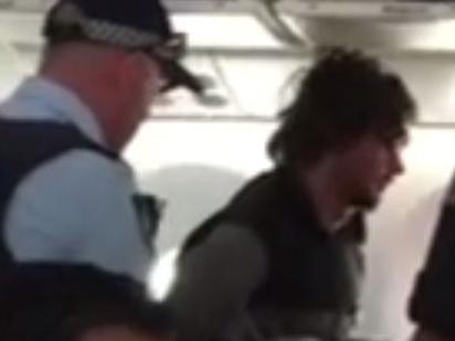 Man tackled trying to open plane door