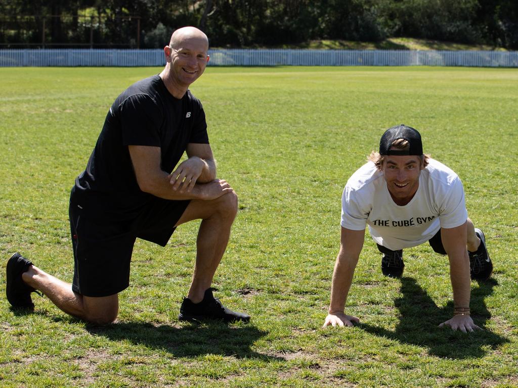 Hayden Quinn shows Adam MacDougall some of his fitness moves. Picture: Ray Bartholomeusz