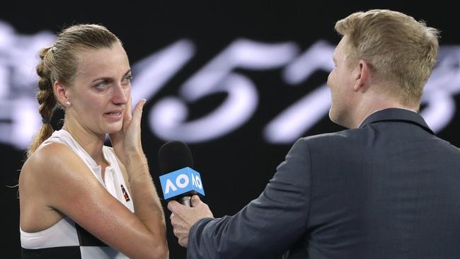 Petra Kvitova sheds a tear as she is interviewed by Jim Courier following her quarter-final victory. Picture: AP