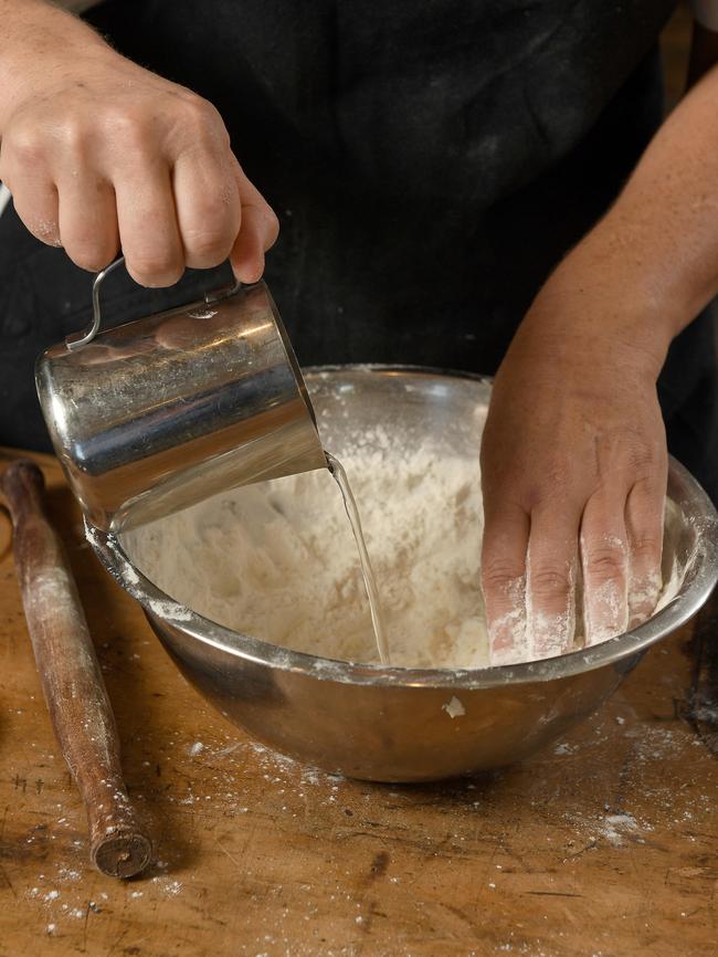 2. Adding water to flour.