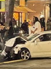 Police arrested a man sitting on top of a vehicle after it collided with other cars and pedestrians in Bourke Street on Friday evening. Picture: Supplied.