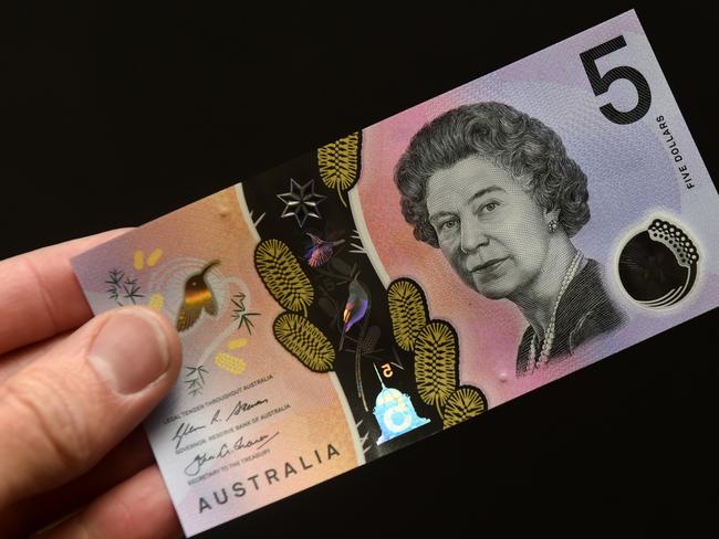 A new Australian five dollar banknote is displayed in Sydney on Thursday, Sept. 1, 2016. The new note, which came into circularion today, arose following a campaign from 15-year-old Connor McLeod, who is visually impaired, that amassed 57,000 supporters targeting the Reserve Bank of Australia. (AAP Image/Paul Miller) NO ARCHIVING