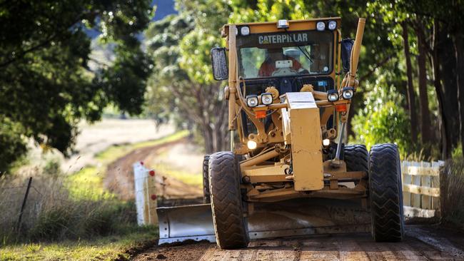 Tasman Highway will be closed from Friday for around a month making it difficult to access the towns of Triabunna and Orford, a grader on Wielangta Road. Picture: Chris Kidd