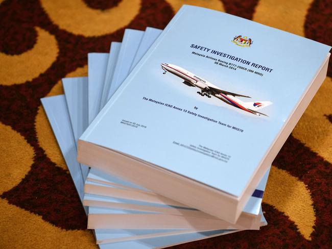 Copies of the MH370 safety investigations report are seen on the floor during a media briefing in Putrajaya, outside Kuala Lumpur. Picture: AFP