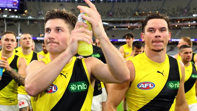 PERTH, AUSTRALIA - JUNE 10: Liam Baker and Daniel Rioli of the Tigers lead the team from the field after winning the round 13 AFL match between Fremantle Dockers and Richmond Tigers at Optus Stadium, on June 10, 2023, in Perth, Australia. (Photo by Paul Kane/Getty Images)