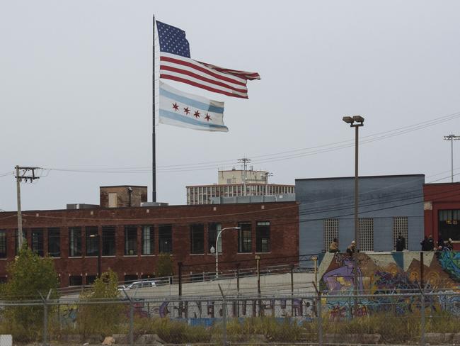 A ripped American flag flies above a Chicago Flag in the River West neighbourhood of Chicago, Illinois, USA. Picture: Angus Mordant for News Corp Australia