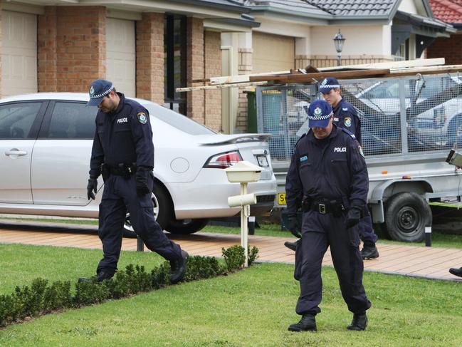 Dozens of police canvased the Woongarrah suburb in search for clues into the murder of Wyong High School teacher Amanda Carter.