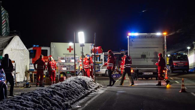 Rescuers continue the search into the night. Picture: AFP