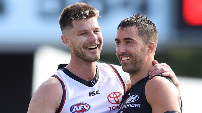 GOLD COAST, AUSTRALIA - SEPTEMBER 13: Bryce Gibbs of the Crows hugs Kade Simpson of the Blues at the end of the match during the round 17 AFL match between the Carlton Blues and the Adelaide Crows at Metricon Stadium on September 13, 2020 in Gold Coast, Australia. (Photo by Chris Hyde/Getty Images)