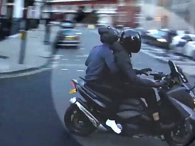 A screen grab of moped-riding thieves fleeing after dousing a man with liquid near Harrods department store in London in 2017. Picture: AP