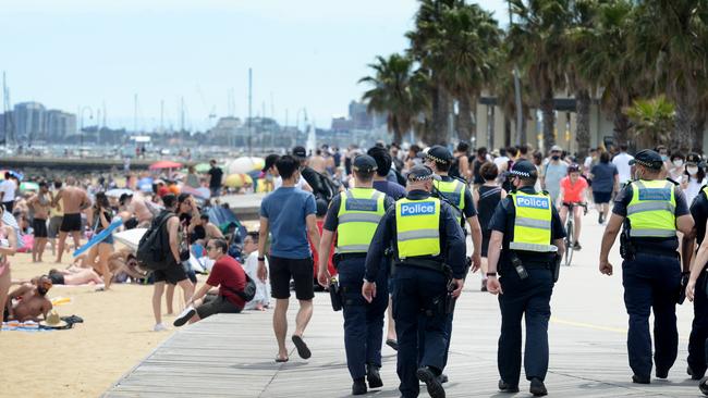 Police and Protective Service Officers patrol as crowds flock to St Kilda Beach. Picture: NCA NewsWire / Andrew Henshaw