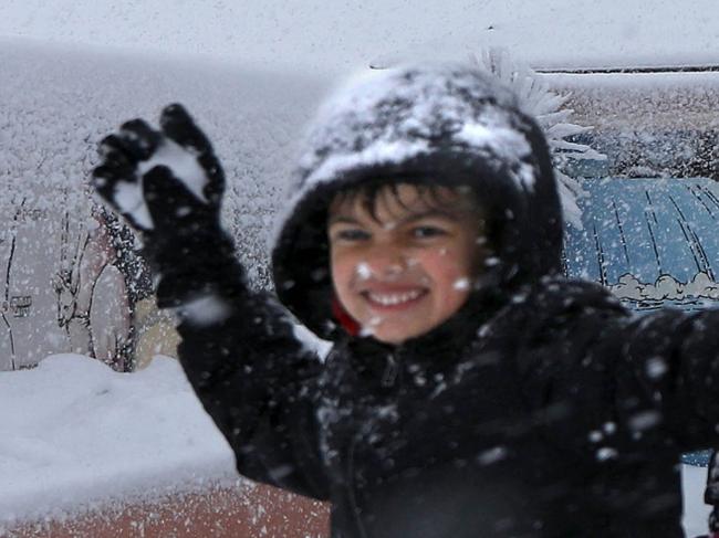 SUNDAY TELEGRAPH. Snow hits Oberon this morning. Kids are shot infant of the Big Trout Motor Inn ,  Hunter Ratnam 7 years of Blacktown throws a snow ball in Oberon Picture Grant Turner