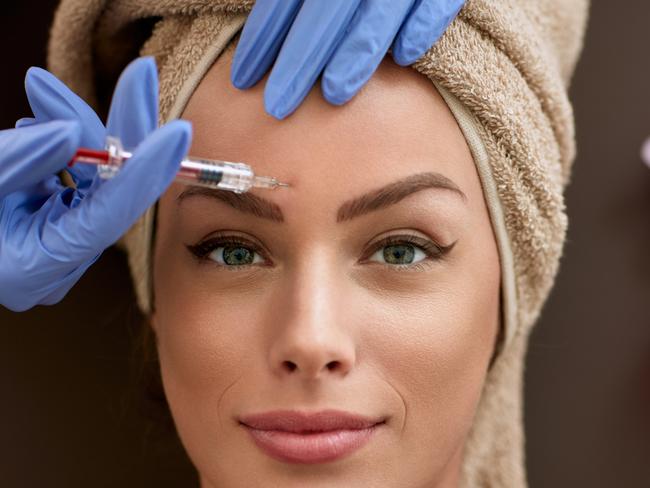 REAL DOLLS FEATURE stock image.Picture: iStock Beauty woman giving injections. as correction of wrinkles, cosmetic treatments