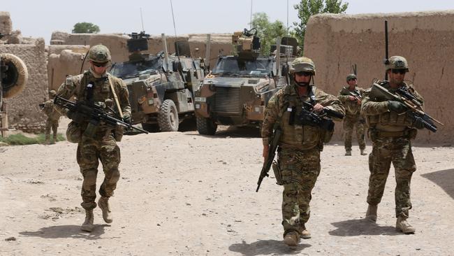 Ex Australian Army photographer, Chris Moore (centre) on patrol Tarin Kowt Afghanistan. Picture: Supplied