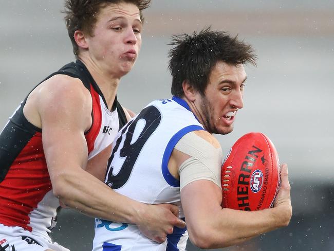 North Melbourne’s Sam Wright tries to break free from St Kilda youngster Jack Billings. Picture: Michael Dodge