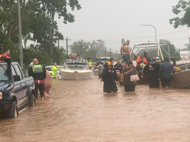 Rescue crews drop people off at the Ballina Street Bridge in South Lismore on February 28, 2022. Picture: Cath Piltz