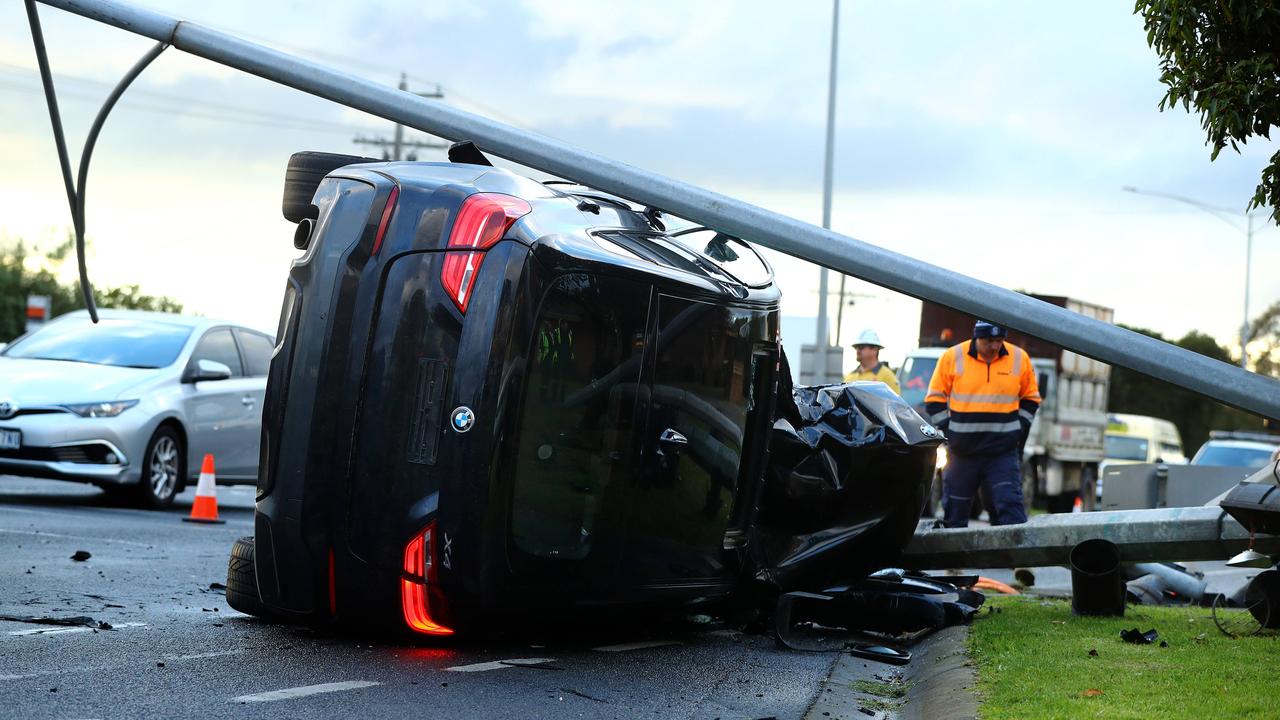 A black BMW smashed into a light pole on the Bellarine Hwy. Picture: Alison Wynd