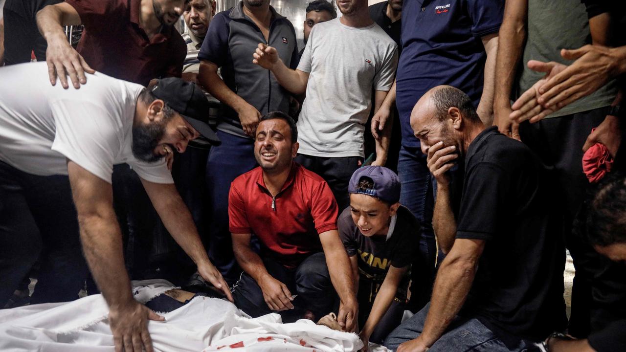 Family members and relatives mourn over the bodies of Palestinian militants killed in the latest infiltration operation into Israel, at the mortuary of a hospital in Gaza City. Picture: AFP