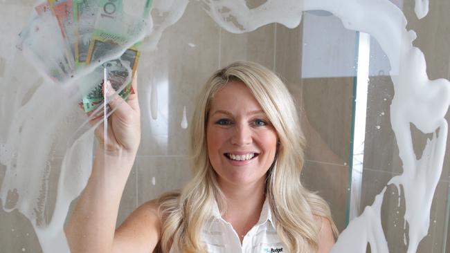 19.2.2015. MyBudget founder Tammy May cleaning a foamy shower screen with cash. For story about saving money on cleaning products. pic tait schmaal.