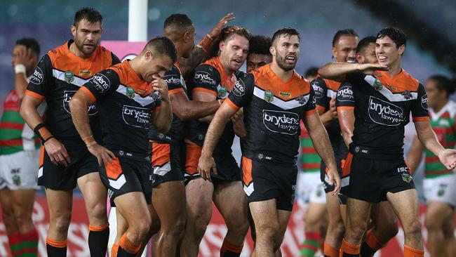 Chris Lawrence celebrates a try with his Tigers teammates.